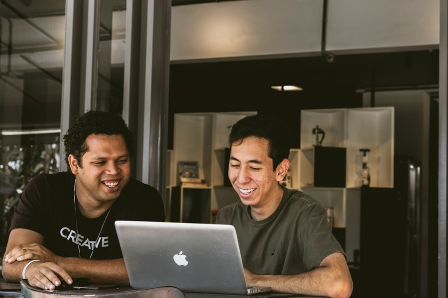Two people planning a project together at a laptop